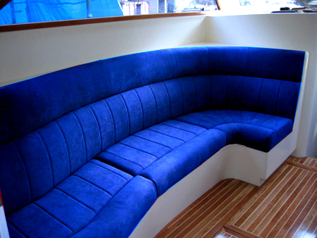 Curved boat cabin lounge upholstered in deep blue